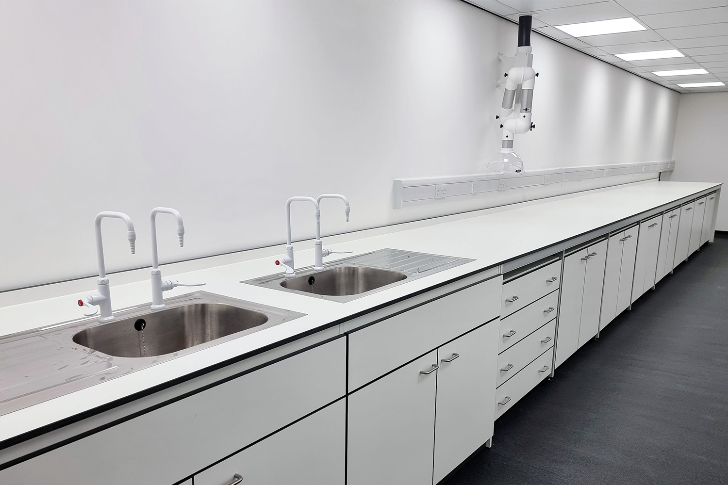 ALS Labs Ltd's pedestal laboratory furniture and chemical resistant worksurfaces including stainless steel sink and drainers at SBZ Corporation